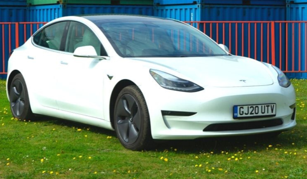 A white tesla model 3 angled to the right