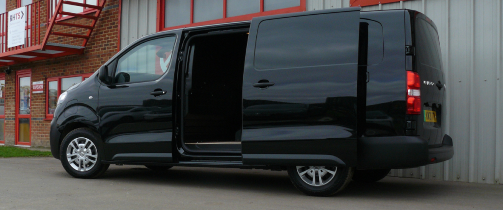 Black Vivaro-e facing left with side door open.