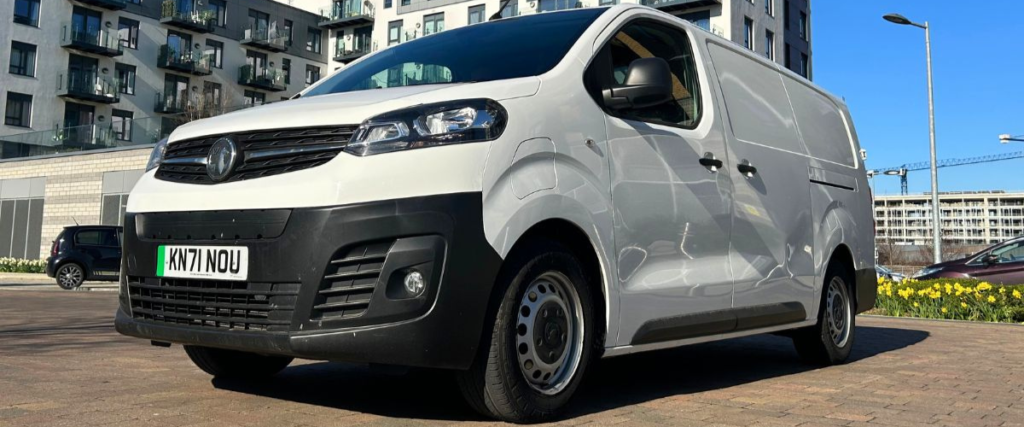 White Vauxhall Vivaro-e van facing forward at an angle.