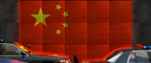 Chinese flag with cars in front.